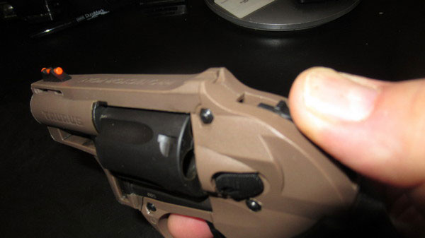 Thumb cocking the Taurus M605 Revolver