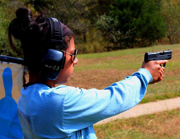 The 9mm S&W Shield in the shooting grip of a 5' 2