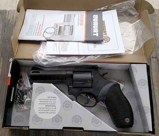 Taurus Tracker .44 Magnum In The Box, with a lock, one extra grip, and manual